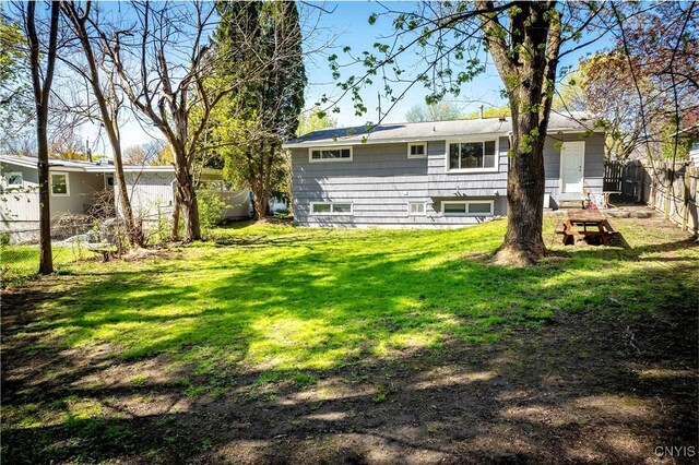 216 Pine Grove St, Syracuse, NY 13210 - rear view of property featuring a lawn and fence
