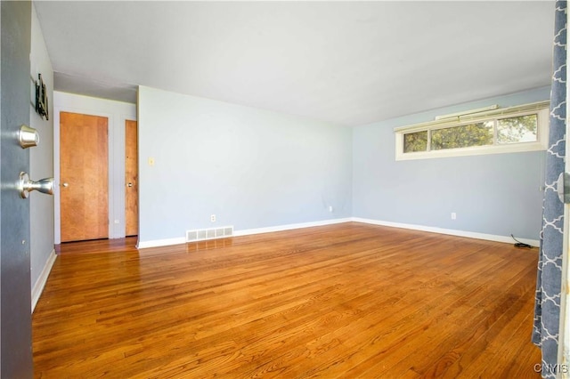 216 Pine Grove St, Syracuse, NY 13210 - unfurnished room featuring baseboards, visible vents, and wood finished floors