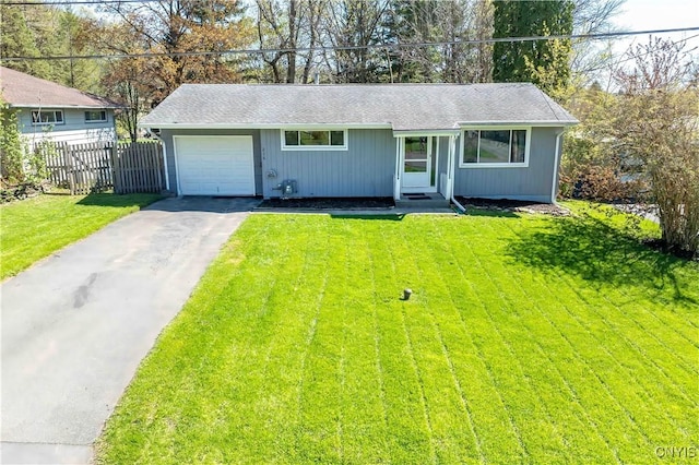 216 Pine Grove St, Syracuse, NY 13210 - ranch-style home with a front yard, fence, aphalt driveway, an attached garage, and a shingled roof