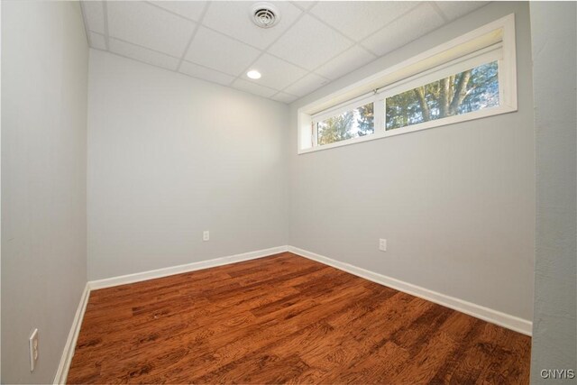 216 Pine Grove St, Syracuse, NY 13210 - unfurnished room with baseboards, dark wood finished floors, a drop ceiling, and visible vents