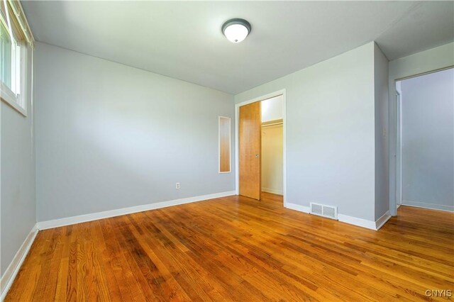 216 Pine Grove St, Syracuse, NY 13210 - unfurnished bedroom featuring baseboards, a closet, wood finished floors, and visible vents