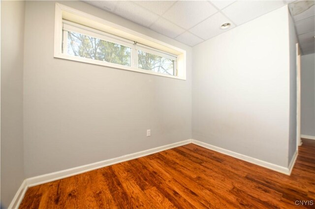 216 Pine Grove St, Syracuse, NY 13210 - spare room with dark wood-style flooring, baseboards, and a paneled ceiling