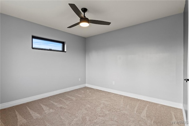 empty room with baseboards, ceiling fan, and carpet flooring