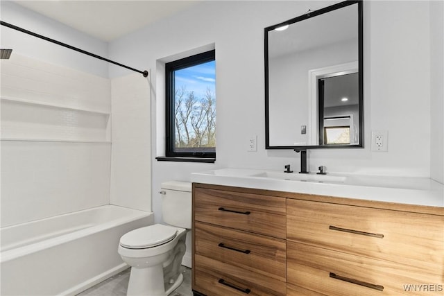 bathroom featuring vanity, bathing tub / shower combination, and toilet