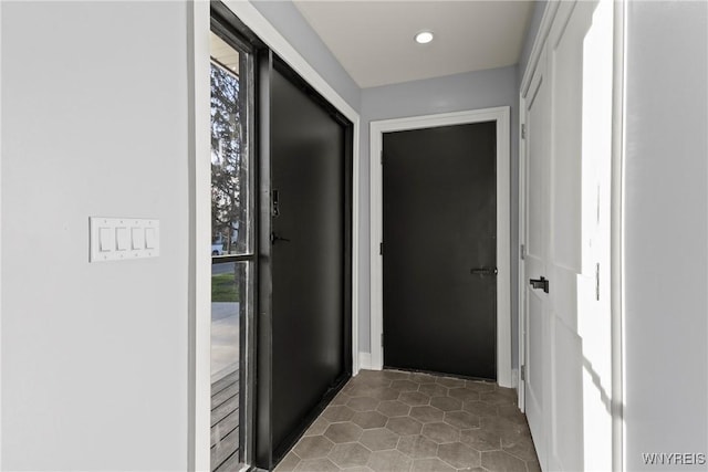 hallway featuring recessed lighting and tile patterned flooring