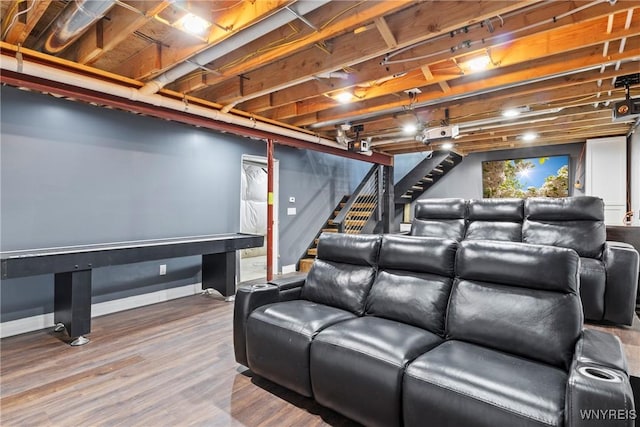 home theater room featuring baseboards and wood finished floors
