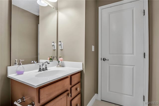 bathroom featuring tile patterned floors, baseboards, and vanity