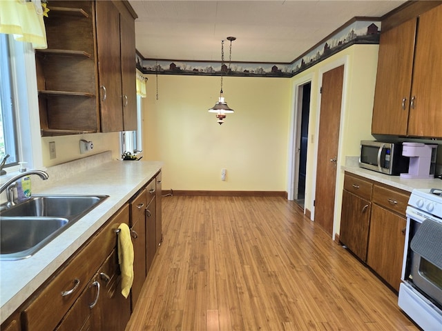 kitchen with open shelves, a sink, light countertops, white range with electric cooktop, and stainless steel microwave