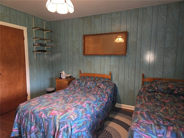 bedroom with wood walls