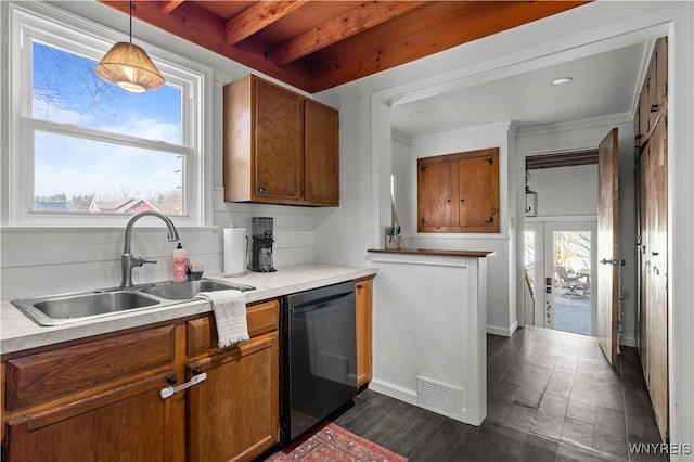 kitchen with black dishwasher, brown cabinets, a healthy amount of sunlight, and a sink