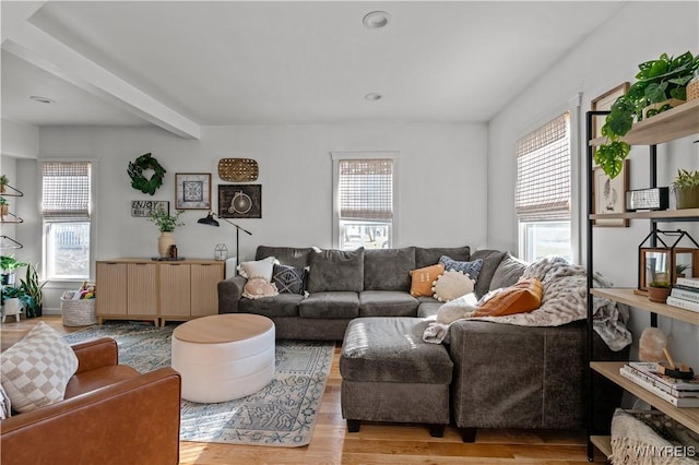 living room with beam ceiling and wood finished floors