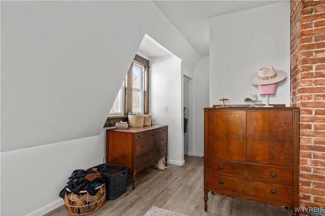 bedroom with baseboards and light wood finished floors
