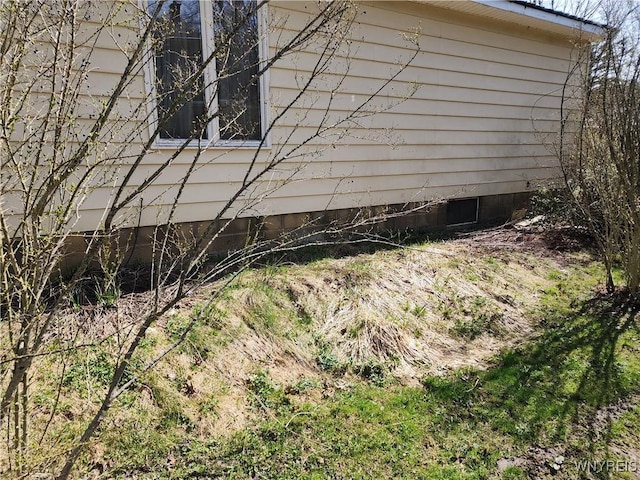 view of side of home featuring crawl space