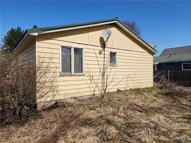 view of home's exterior featuring fence