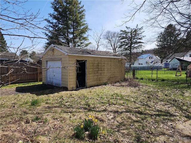 view of outbuilding featuring fence and an outdoor structure