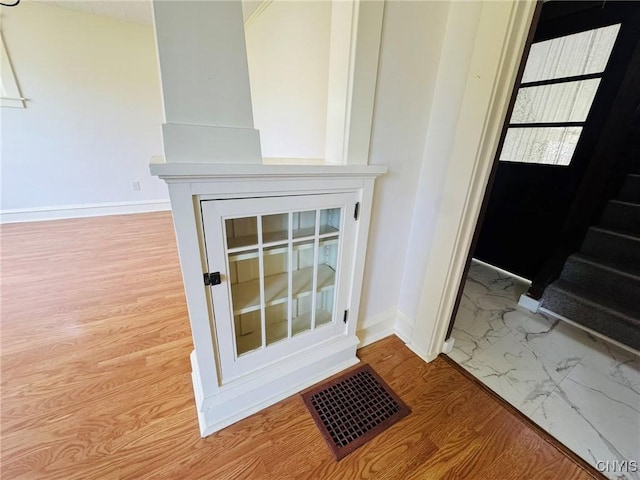 details with visible vents, baseboards, and wood finished floors