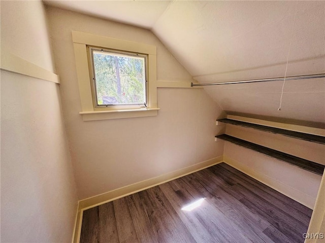 bonus room with baseboards, dark wood-style floors, and lofted ceiling