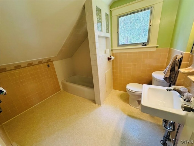 full bathroom with walk in shower, toilet, tile walls, and wainscoting