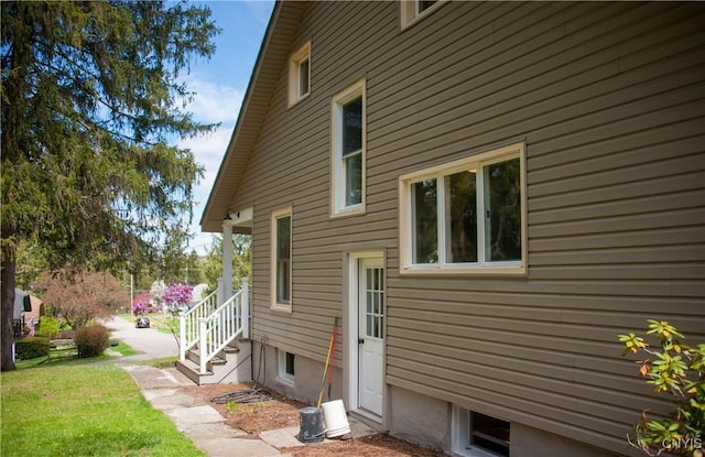 view of side of property with a lawn