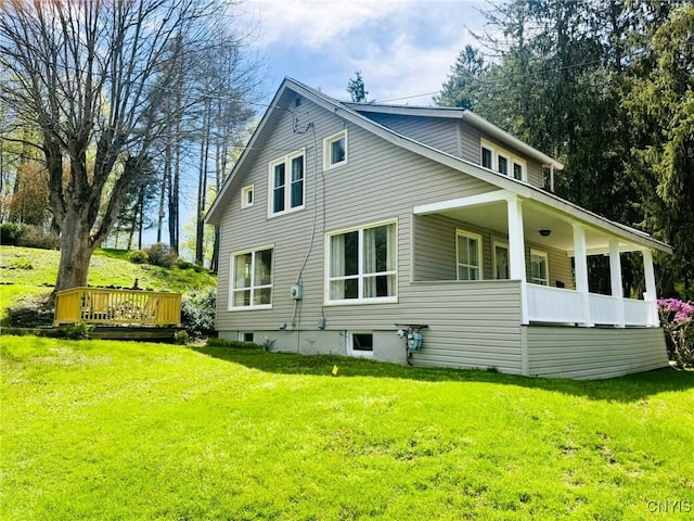 view of side of home with a lawn