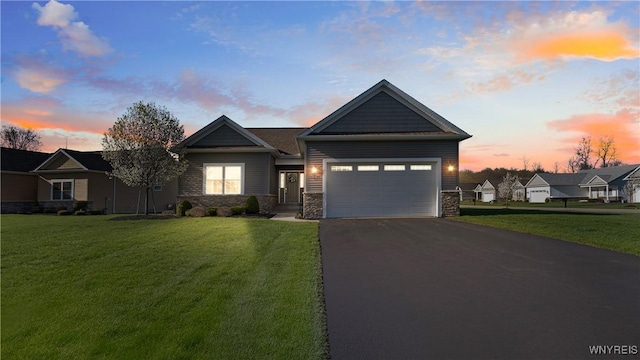 view of front facade with a garage, a front lawn, aphalt driveway, and stone siding