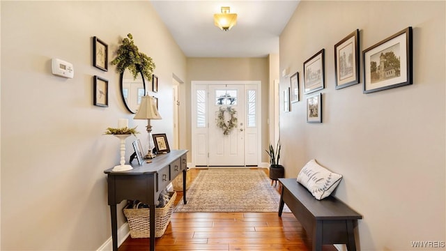 entryway featuring wood-type flooring and baseboards