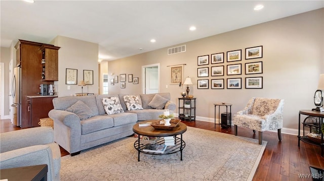 living room with visible vents, recessed lighting, and dark wood finished floors