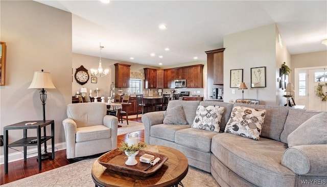 living room with recessed lighting, baseboards, wood finished floors, and a chandelier