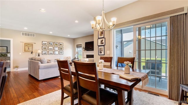 dining room featuring visible vents, recessed lighting, dark wood-type flooring, and a notable chandelier