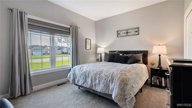 carpeted bedroom with visible vents and baseboards