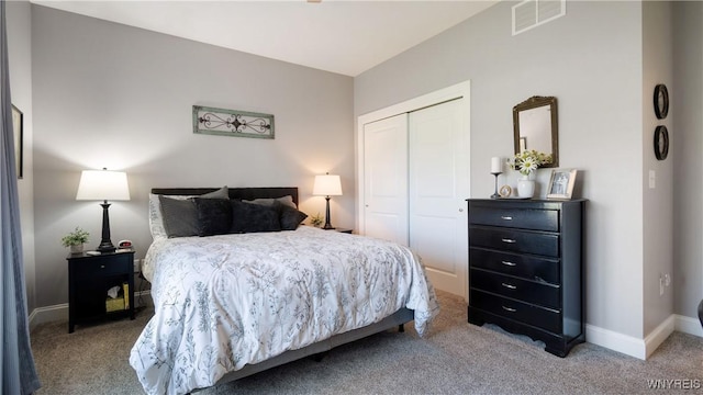 bedroom featuring baseboards, visible vents, carpet, and a closet