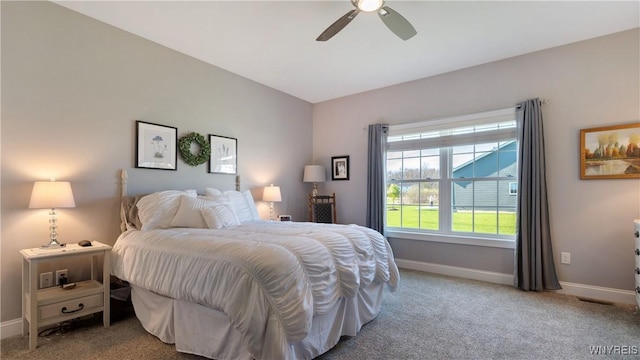 carpeted bedroom with baseboards and a ceiling fan