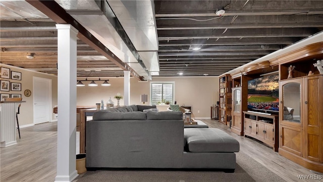 living area with baseboards and light wood finished floors