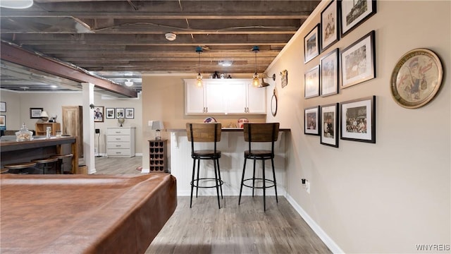 bar with baseboards, pendant lighting, wood finished floors, and pool table