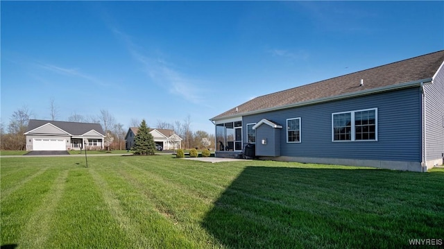 back of property with a lawn and a sunroom