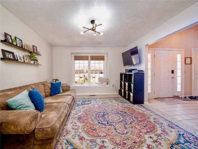 living room with a textured ceiling and a chandelier