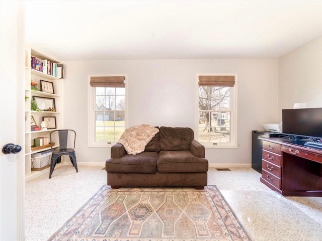 interior space featuring baseboards, light carpet, and visible vents