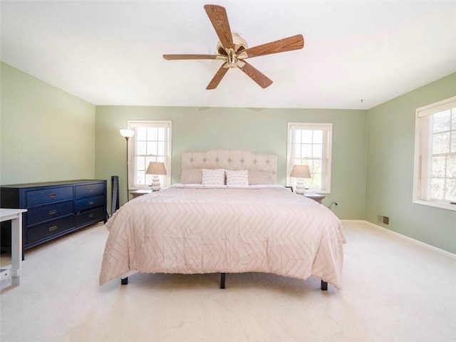 bedroom with baseboards, light colored carpet, and ceiling fan