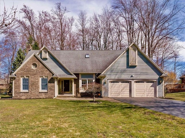 view of front of property featuring a front lawn, brick siding, a garage, aphalt driveway, and a chimney
