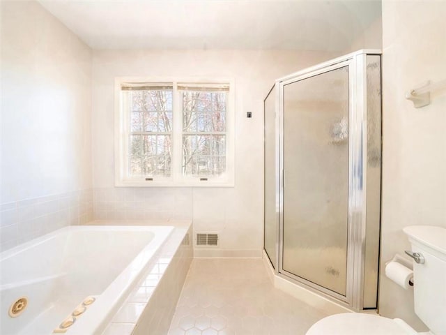 bathroom with a bath, visible vents, tile patterned flooring, a stall shower, and toilet