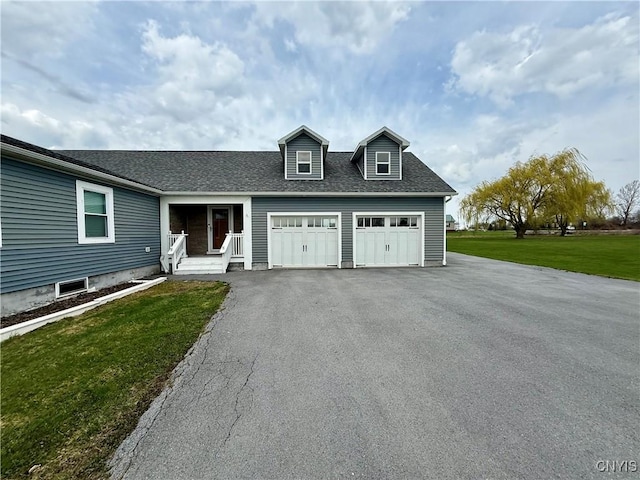 28053 Boat Launch Rd, Lyme, NY 13622 - view of front of home with an attached garage, driveway, a shingled roof, and a front yard
