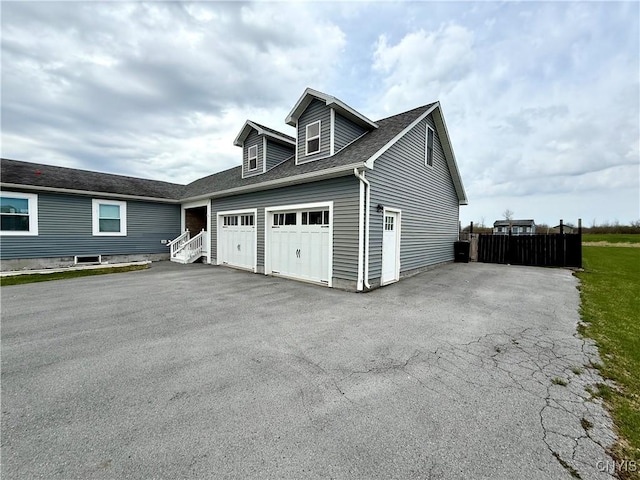 28053 Boat Launch Rd, Lyme, NY 13622 - view of front of home with roof with shingles, fence, a garage, and aphalt driveway