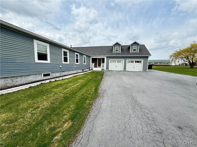 28053 Boat Launch Rd, Lyme, NY 13622 - view of front of home featuring an attached garage, a front lawn, and aphalt driveway