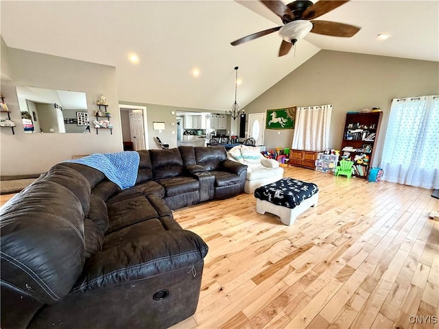 28053 Boat Launch Rd, Lyme, NY 13622 - living area featuring high vaulted ceiling, ceiling fan with notable chandelier, and hardwood / wood-style flooring
