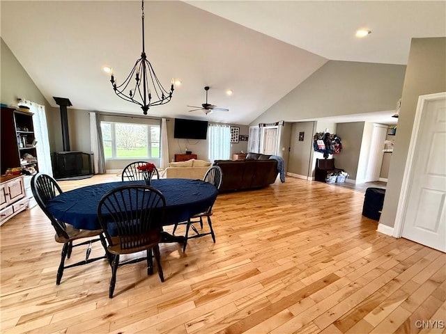28053 Boat Launch Rd, Lyme, NY 13622 - dining room featuring recessed lighting, a wood stove, light wood finished floors, and vaulted ceiling