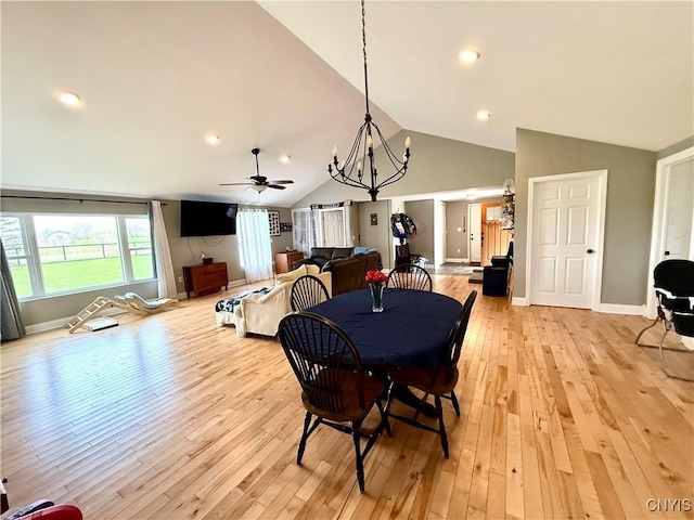 28053 Boat Launch Rd, Lyme, NY 13622 - dining room featuring light wood finished floors, ceiling fan with notable chandelier, recessed lighting, baseboards, and lofted ceiling
