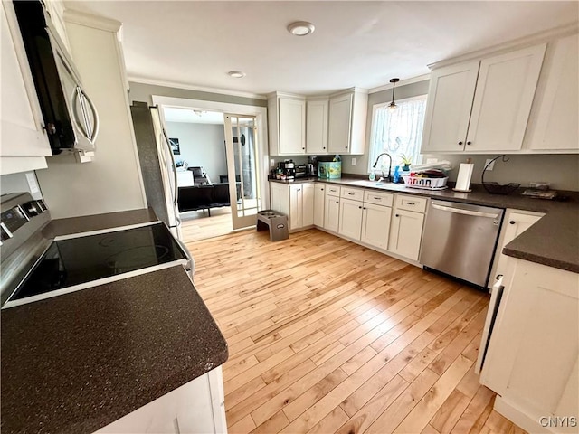 28053 Boat Launch Rd, Lyme, NY 13622 - kitchen featuring light wood-style floors, a sink, dark countertops, and stainless steel appliances