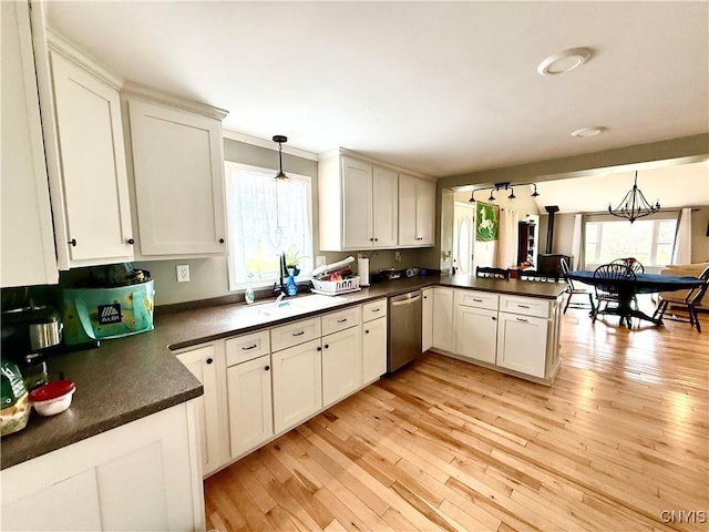 28053 Boat Launch Rd, Lyme, NY 13622 - kitchen with a peninsula, dishwasher, a wealth of natural light, and dark countertops