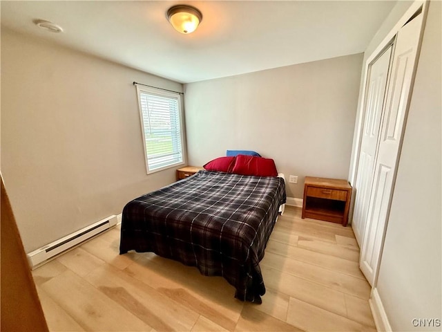 28053 Boat Launch Rd, Lyme, NY 13622 - bedroom featuring baseboards, a baseboard radiator, and light wood-style flooring