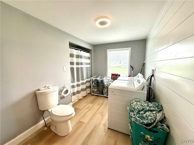 28053 Boat Launch Rd, Lyme, NY 13622 - laundry room featuring laundry area, baseboards, washing machine and dryer, and light wood-type flooring